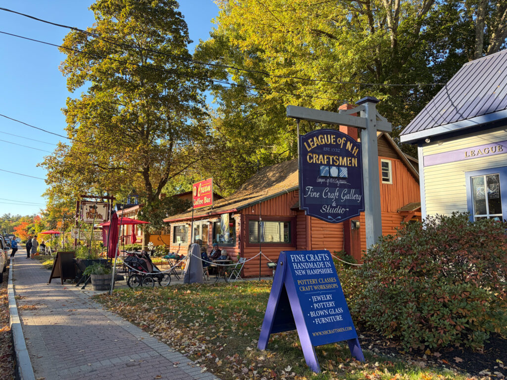 League of NH Craftsmen gallery and outdoor café seating in North Conway Village during fall.